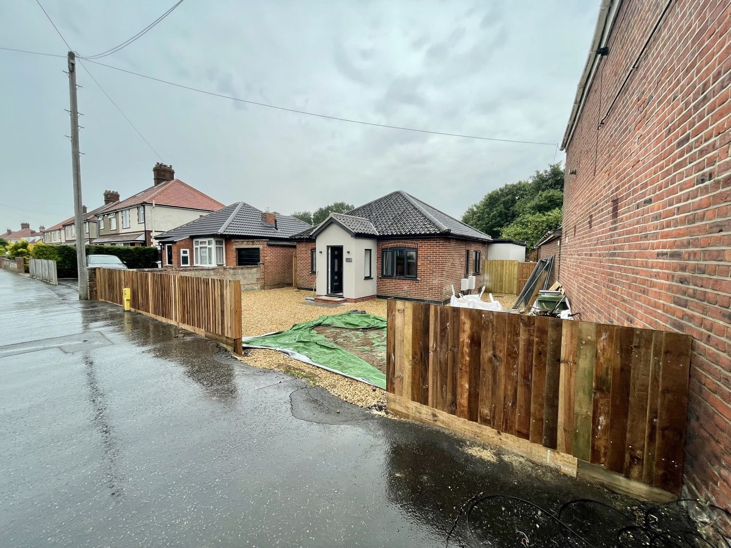 Front of the refurbished bungalow with new timber fencing and gravel frontage