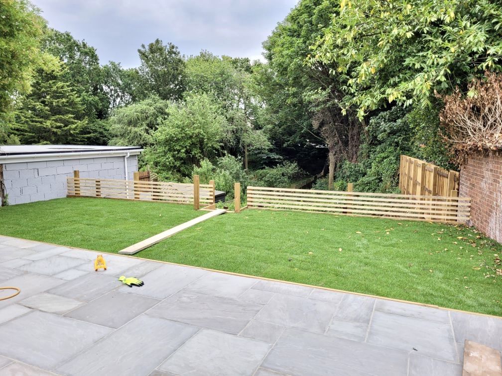 Rear garden with new lawn, patio and slatted fencing
