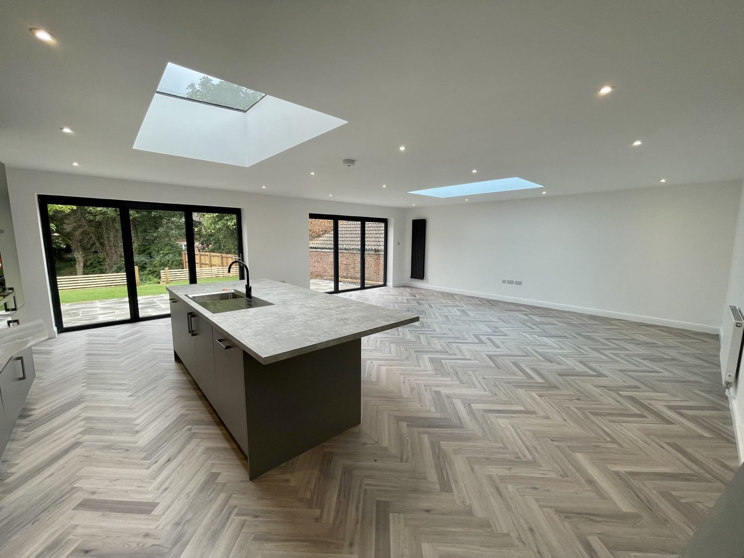 Open-plan room with a kitchen island under roof lights